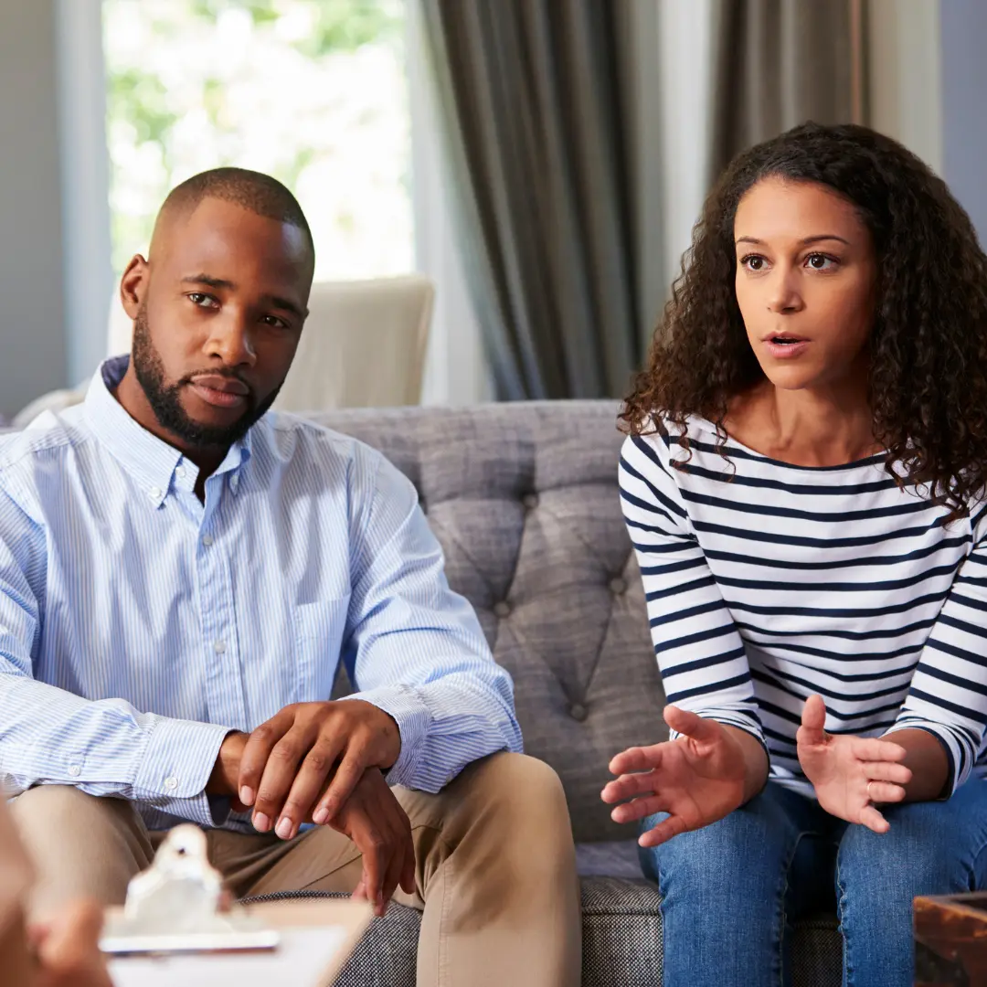 couple sitting on the couch woman talking